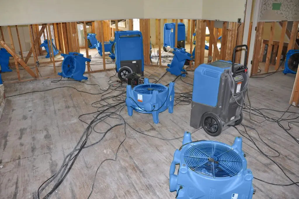 Air movers drying a gutted Cary room after major water damage
